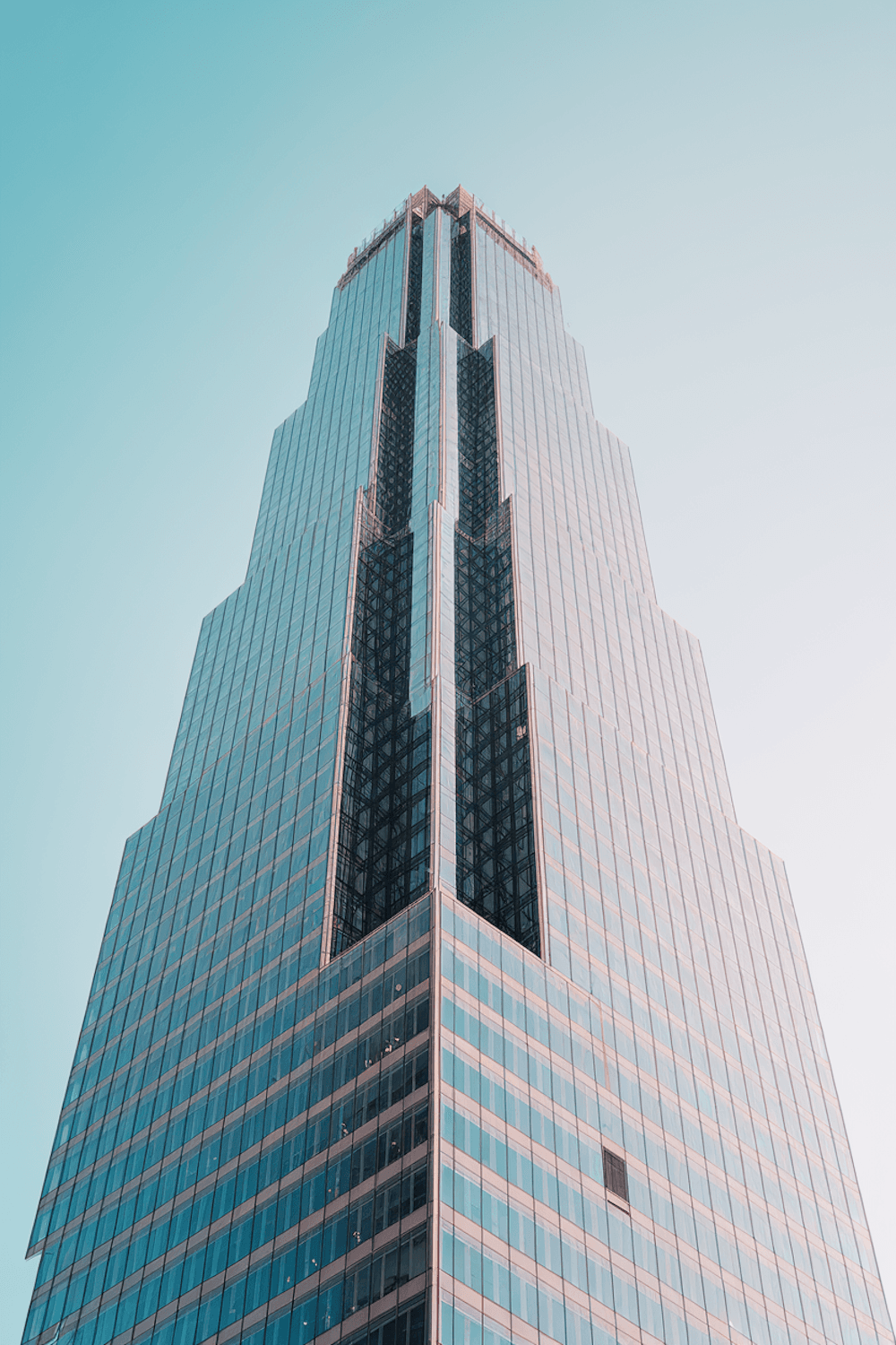 Steel and glass high-rise under construction against a clear sky